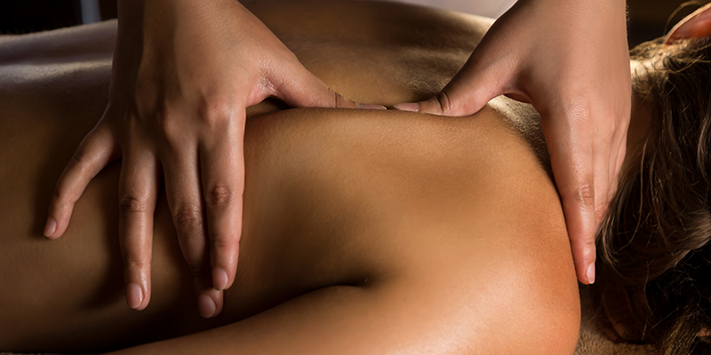 Therapists hands performing shoulder massage